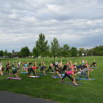 women doing yoga at the park